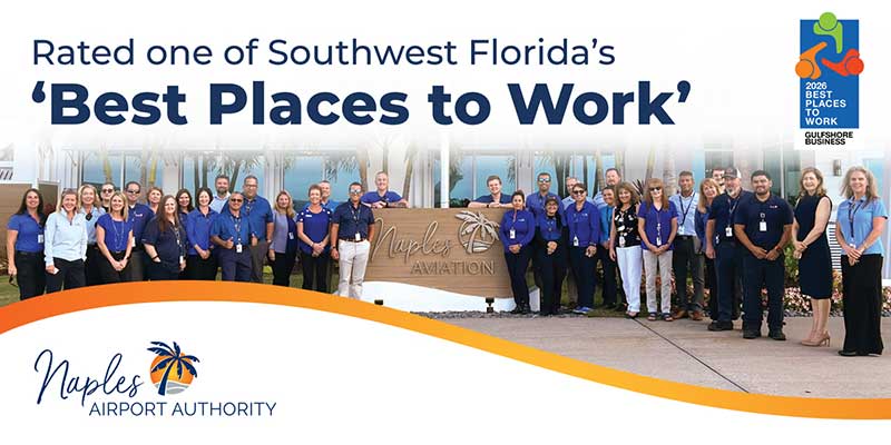 A large group of Naples Airport Authority employees pose outside by a Naples Aviation sign, under a banner naming them a 2023 Best Places to Work in Southwest Florida.